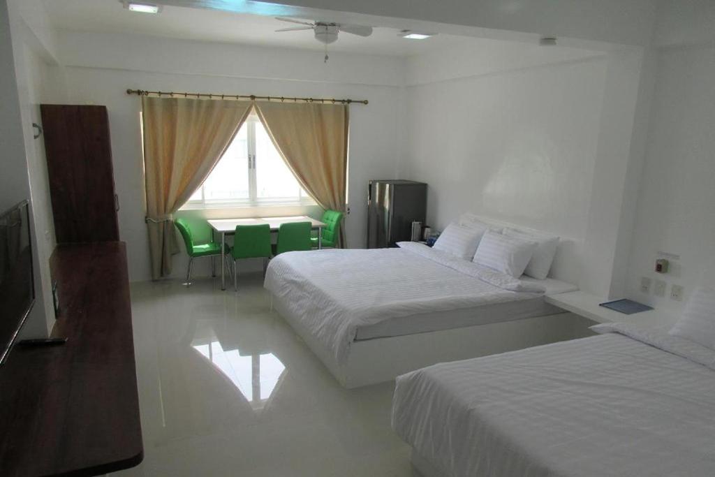 Postel nebo postele na pokoji v ubytování Coron Bluewave Hotel