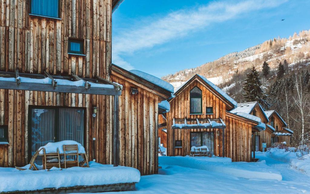 a cabin in the winter with snow on the ground at FerienPark Kreischberg by ALPS RESORTS in Sankt Lorenzen ob Murau