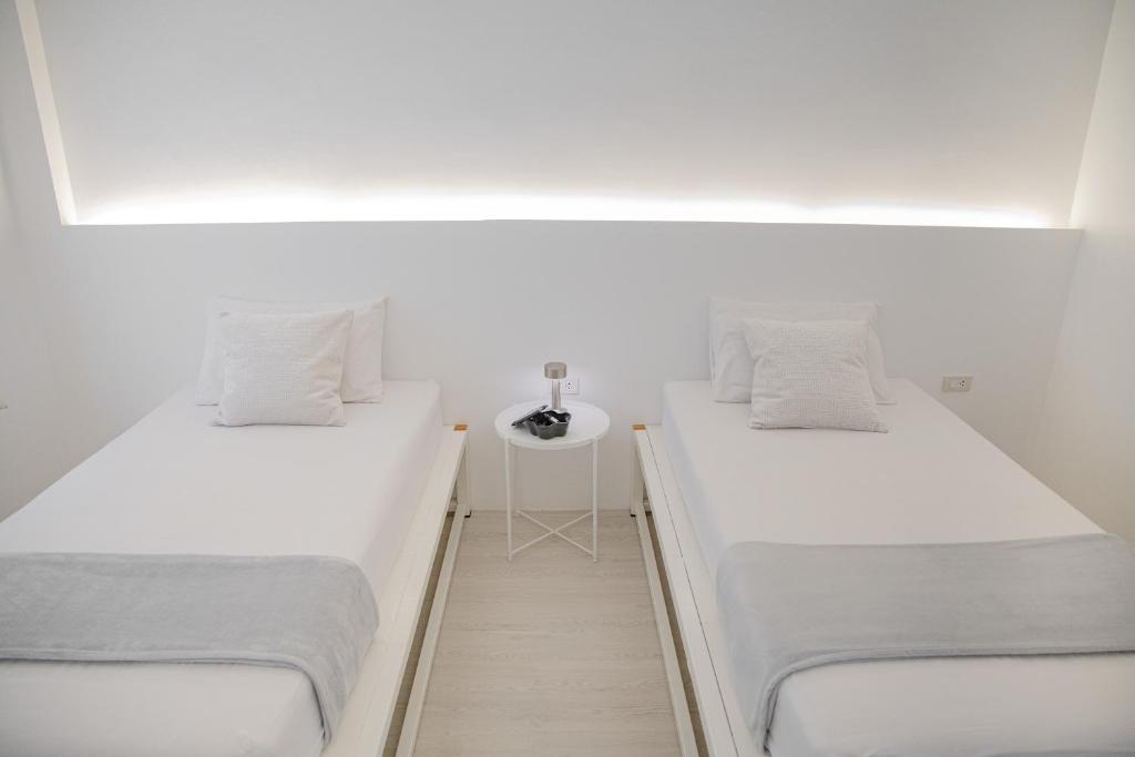Postel nebo postele na pokoji v ubytování HAO Hotel Phuket