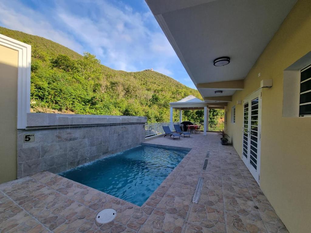 a swimming pool in the backyard of a house at Condo with Pool - Sleeps 8 & bbq facilities in Philipsburg