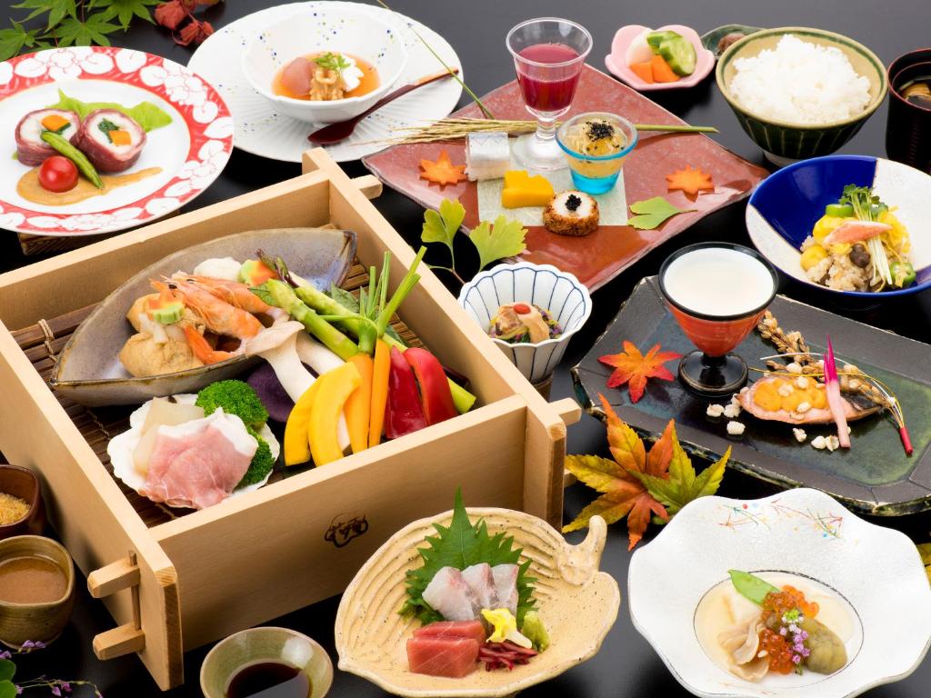 a table topped with boxes of food and plates at Hotel Hanaan in Nikko