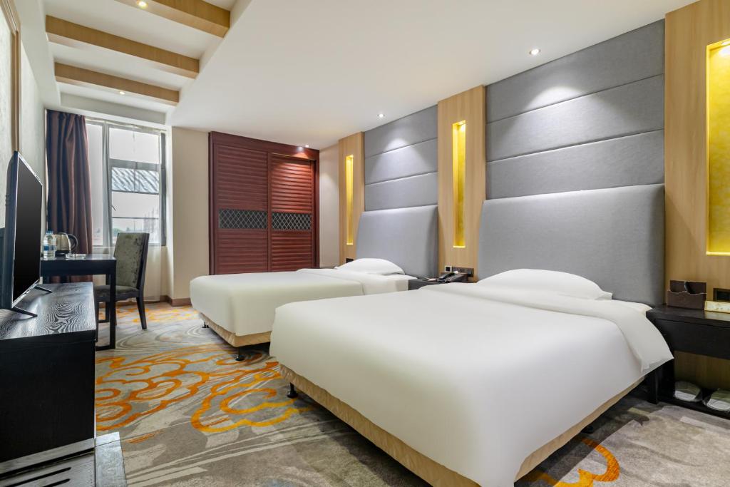 Postel nebo postele na pokoji v ubytování Yi Yun Hotel Guangzhou Baiyun International Airport Branch - Renhe Metro Station