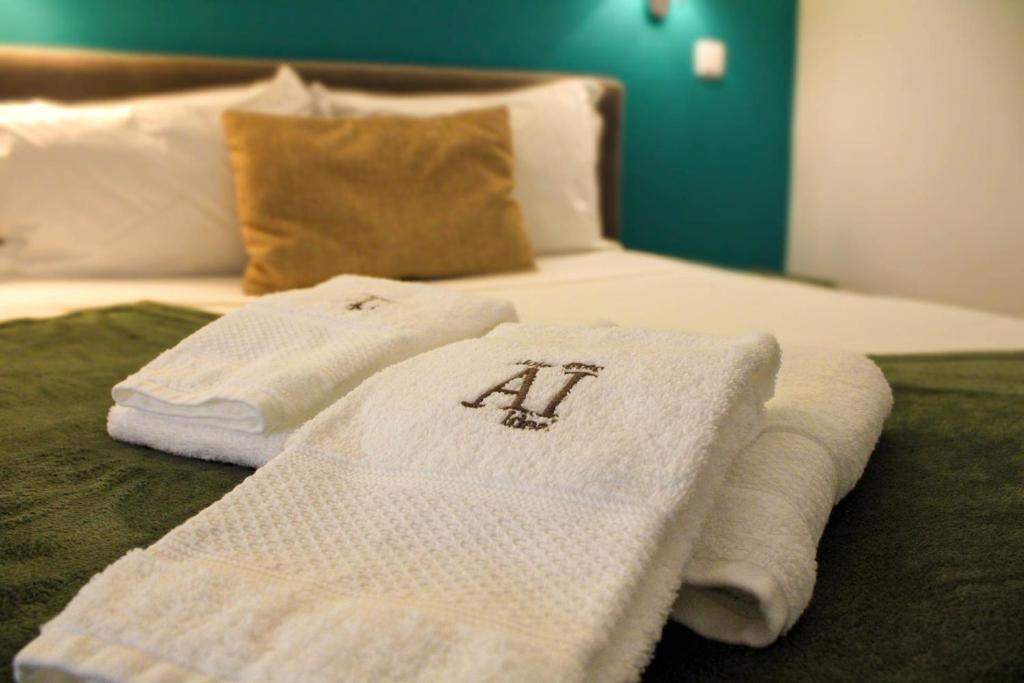 two towels sitting on top of a bed at Casa Jardim in Porto