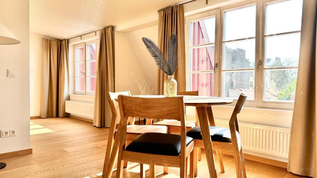 a dining room with a table and chairs and a window at City Center Appartment in Vilnius