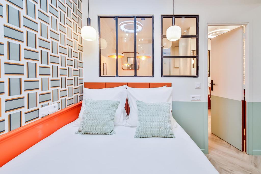 a bedroom with a bed with two pillows at WS Molitor - Auteuil in Paris