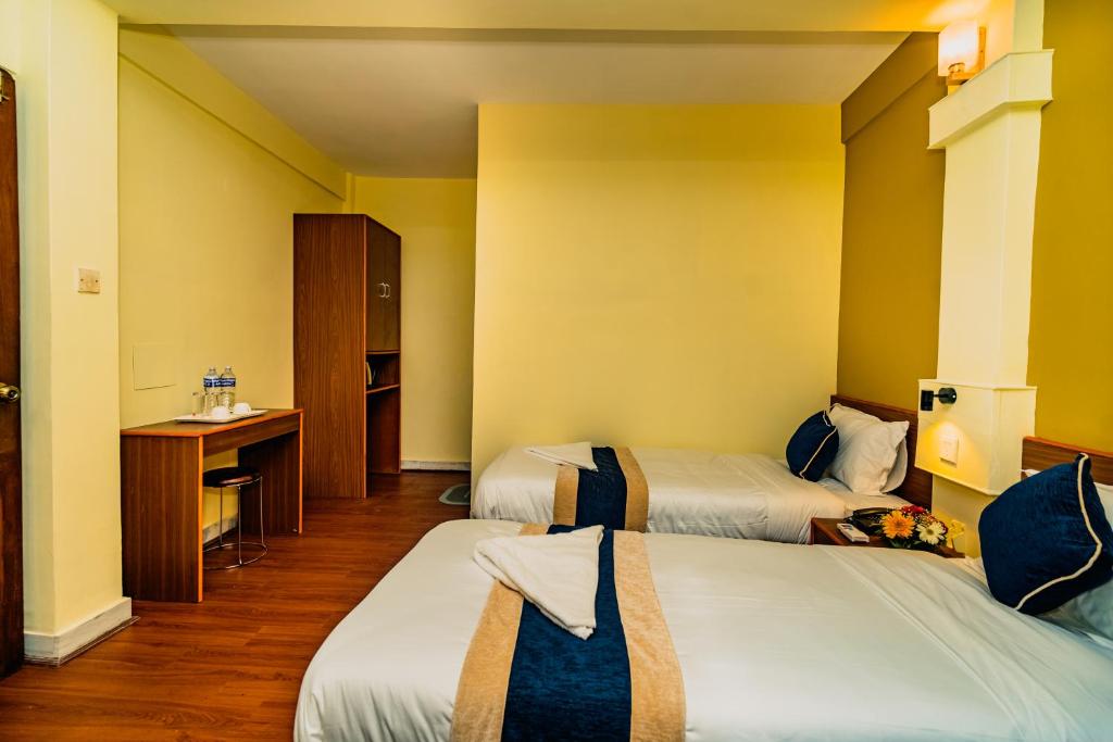 Postelja oz. postelje v sobi nastanitve Hotel Aashraya Home