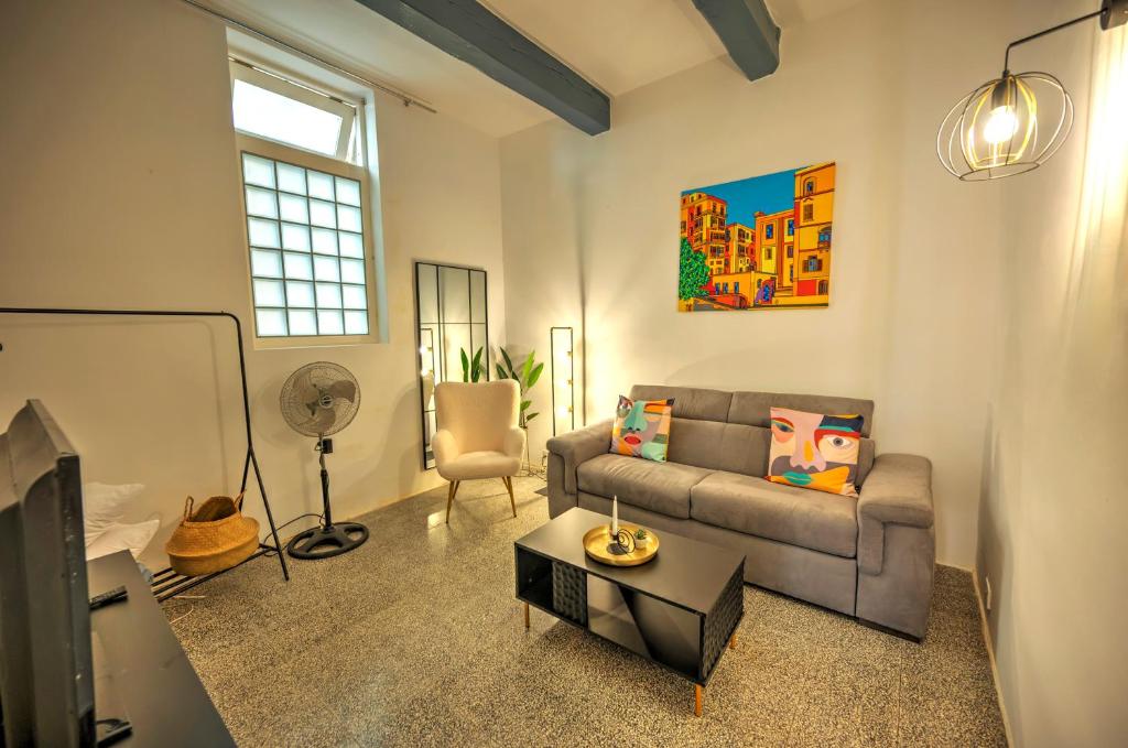 a living room with a couch and a table at Duplex tastefully furnished flat in Valletta MCOP1-1 in Valletta