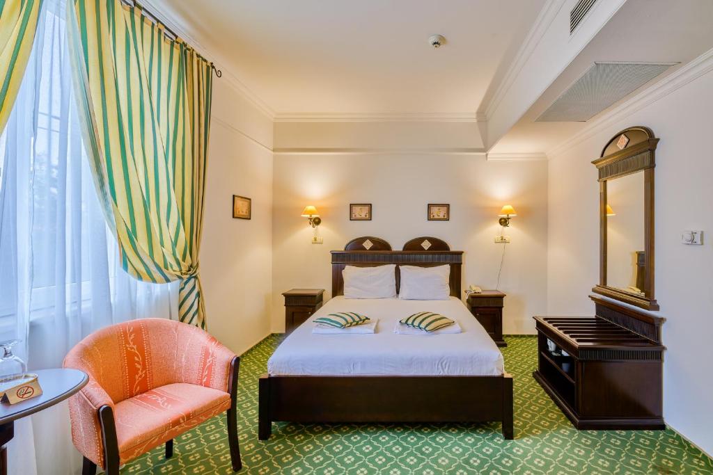 Postel nebo postele na pokoji v ubytování Hotel Classico Timisoara