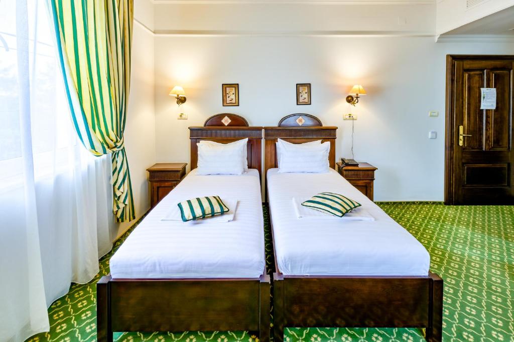 Postel nebo postele na pokoji v ubytování Hotel Classico Timisoara