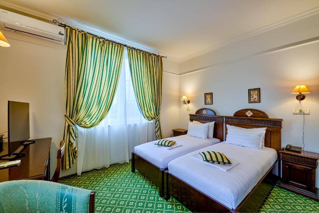 Postel nebo postele na pokoji v ubytování Hotel Classico Timisoara