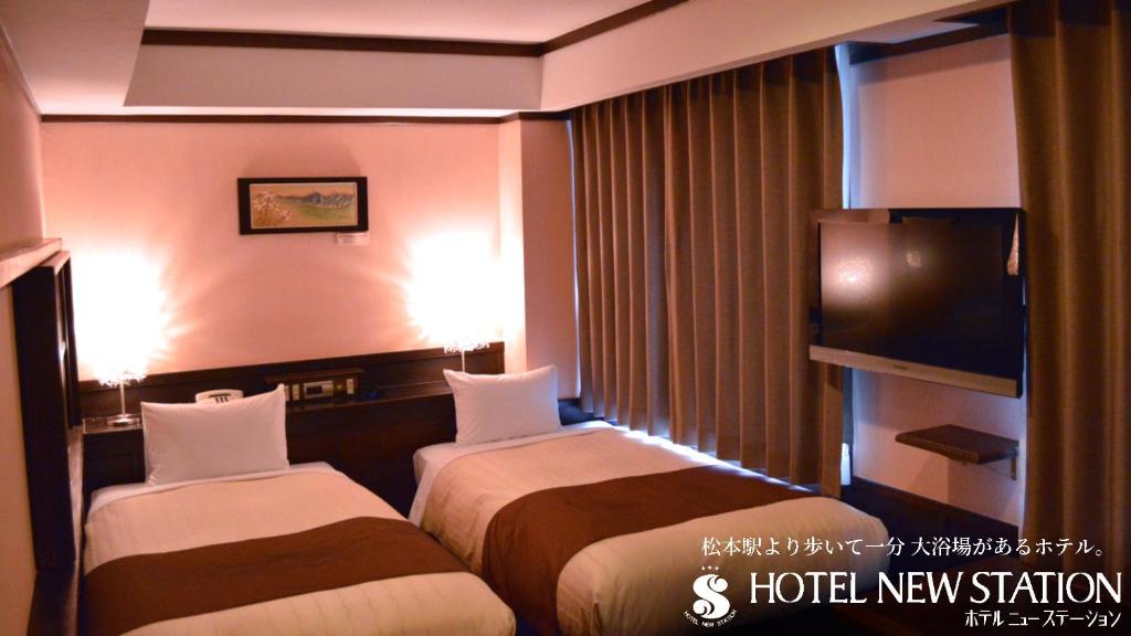 Postel nebo postele na pokoji v ubytování Hotel New Station