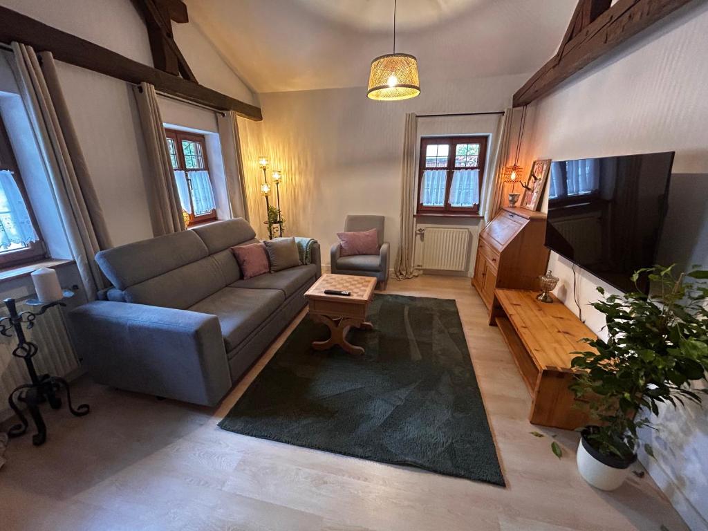 a living room with a couch and a tv at Ferienwohnung Stüberl in Oberammergau