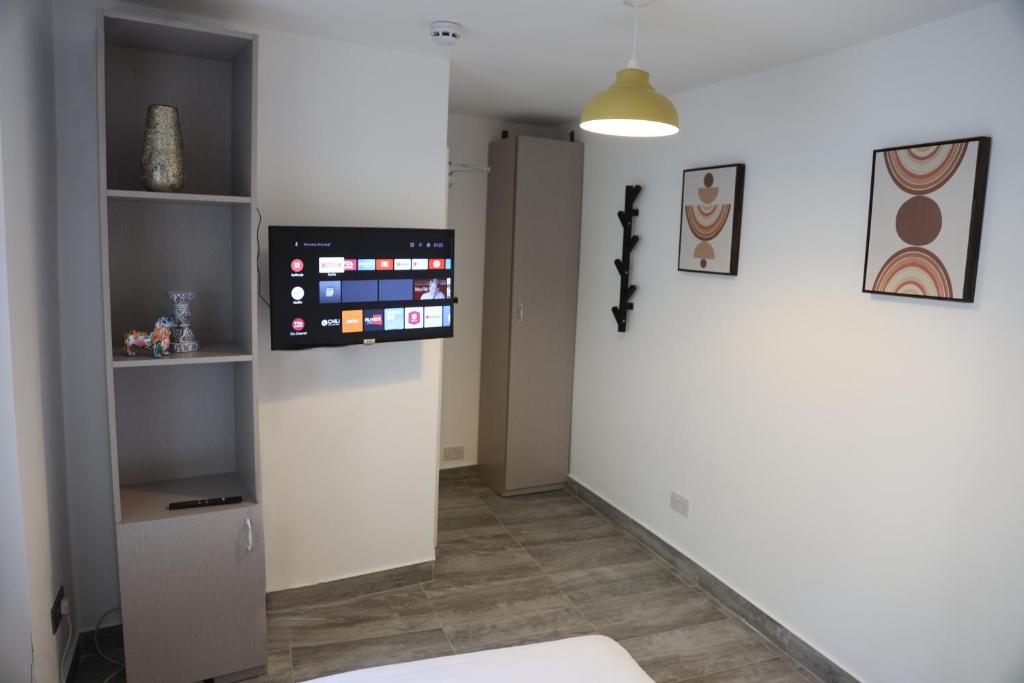 a living room with a tv on the wall at Smashing Studio in London