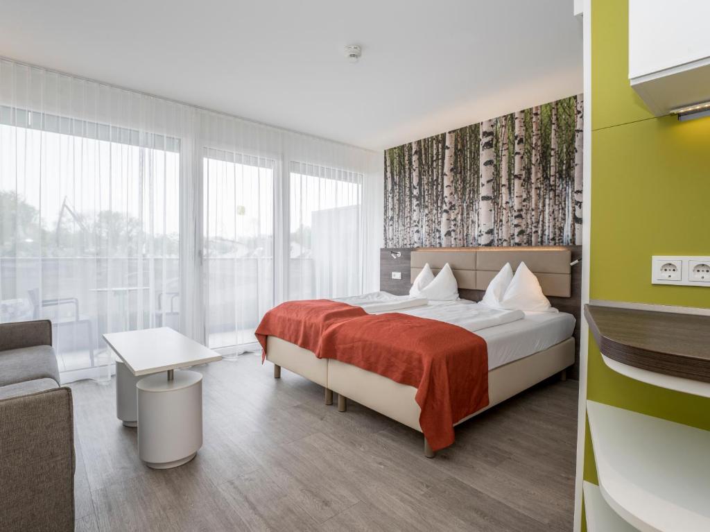 Postel nebo postele na pokoji v ubytování Eco Suite Hotel