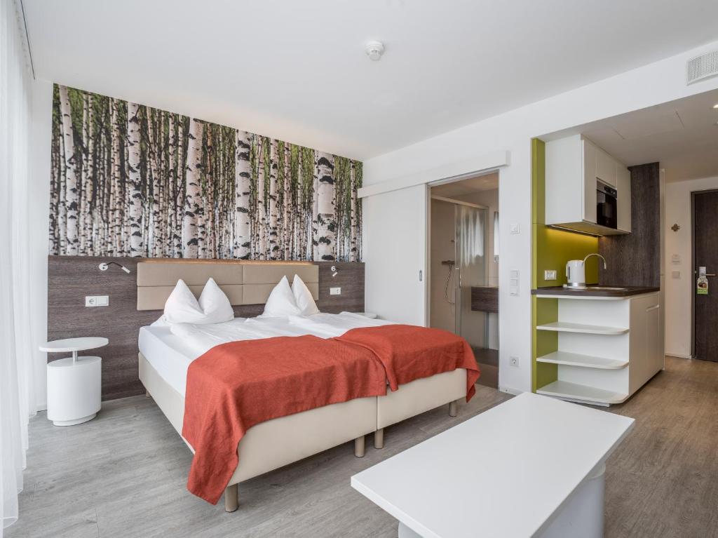 Postel nebo postele na pokoji v ubytování Eco Suite Hotel