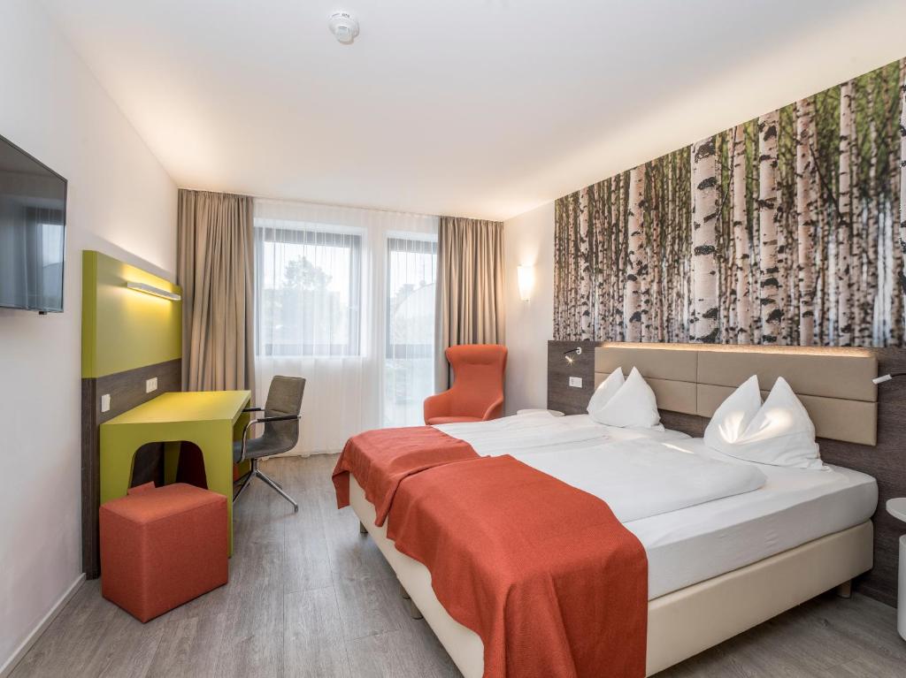 Postel nebo postele na pokoji v ubytování Eco Suite Hotel