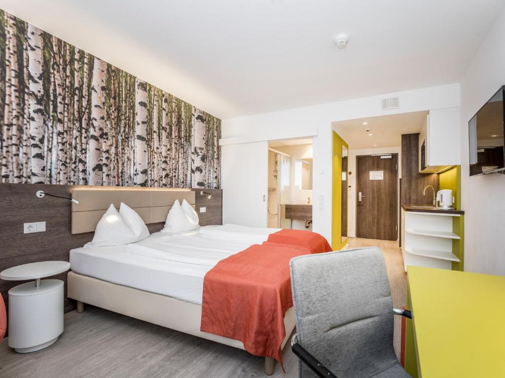 Postel nebo postele na pokoji v ubytování Eco Suite Hotel