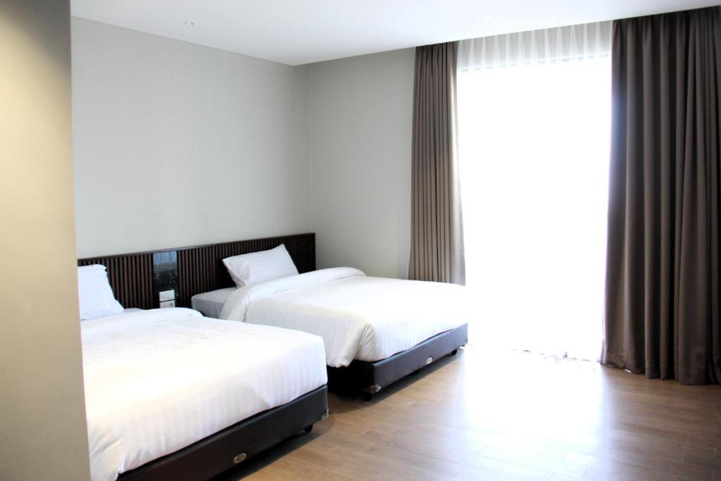 Postel nebo postele na pokoji v ubytování Moscato Hotel