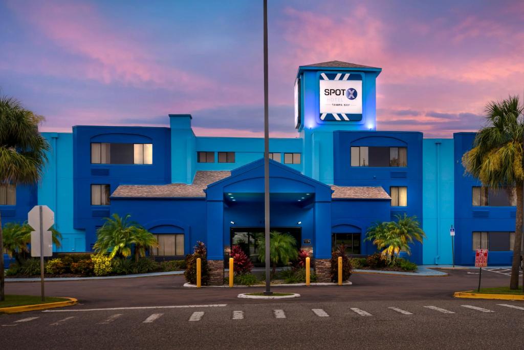 a blue building with a sign on it at Spot X Hotel Wesley Chapel - Tampa Area in Wesley Chapel
