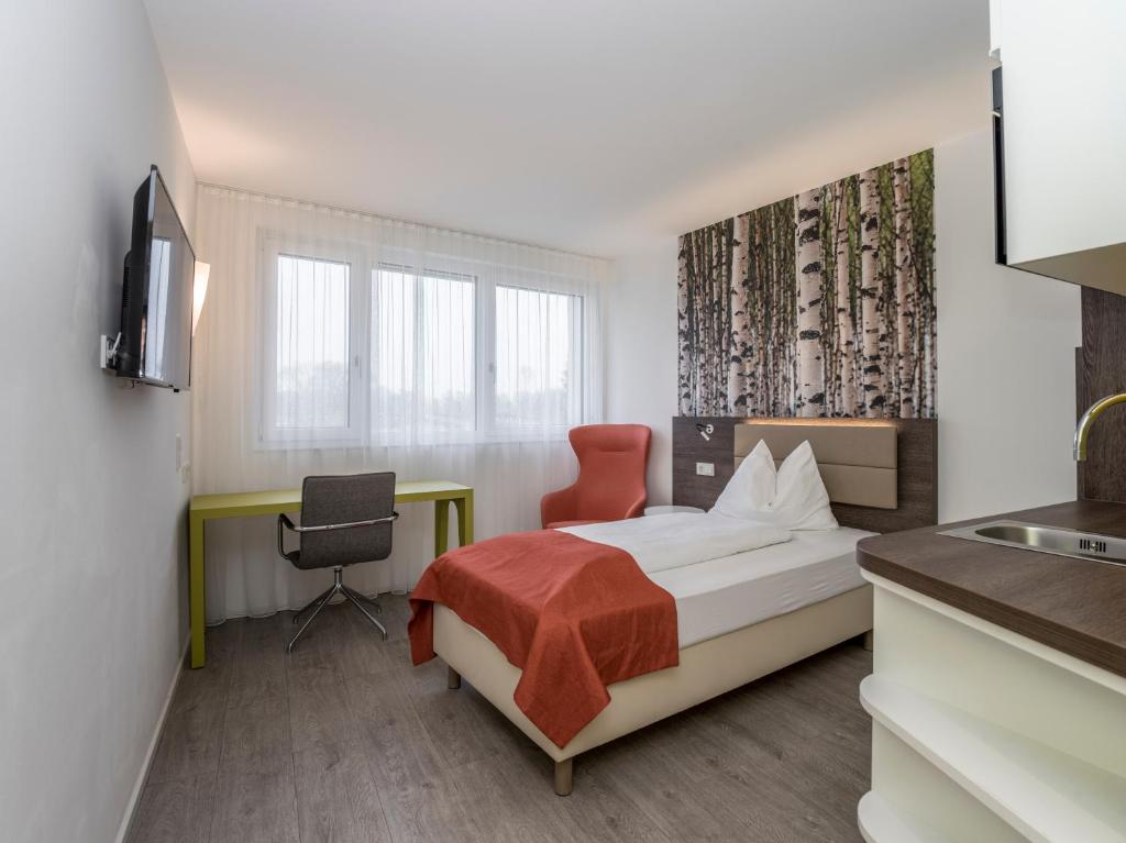 Postel nebo postele na pokoji v ubytování Eco Suite Hotel