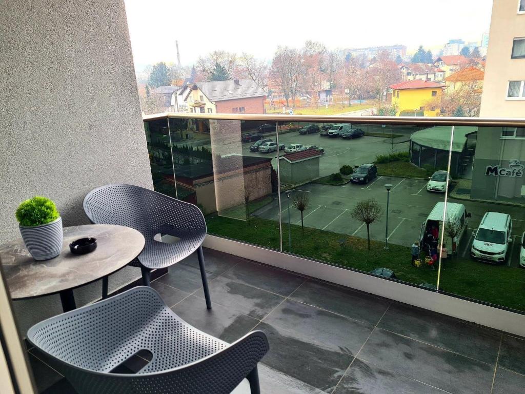 a balcony with a table and chairs and a tennis court at Wellness Apartments - Studio Apartment with Terrace G3 in Varaždin