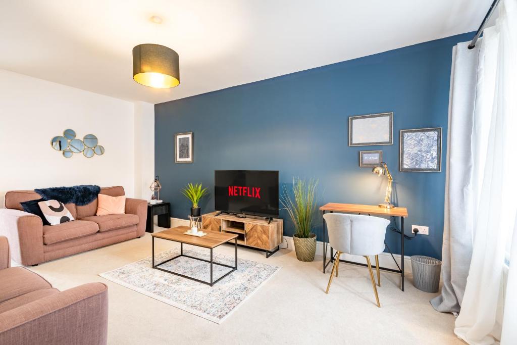 sala de estar con pared de acento azul en Convenient & cosy 3 bed house, en Newport