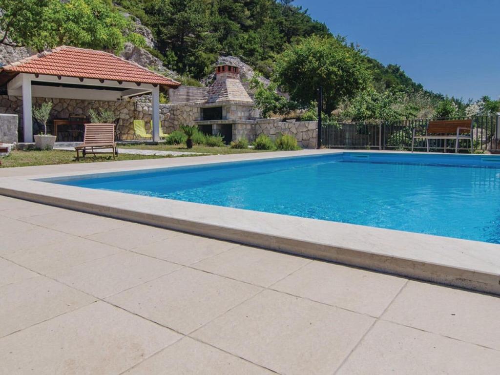 a swimming pool in a yard with a gazebo at Holiday Home Stari Zoganj - Two Bedroom Holiday Home with Terrace and Swimming Pool in Potomje