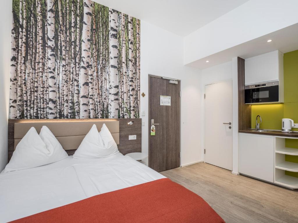 Postel nebo postele na pokoji v ubytování Eco Suite Hotel