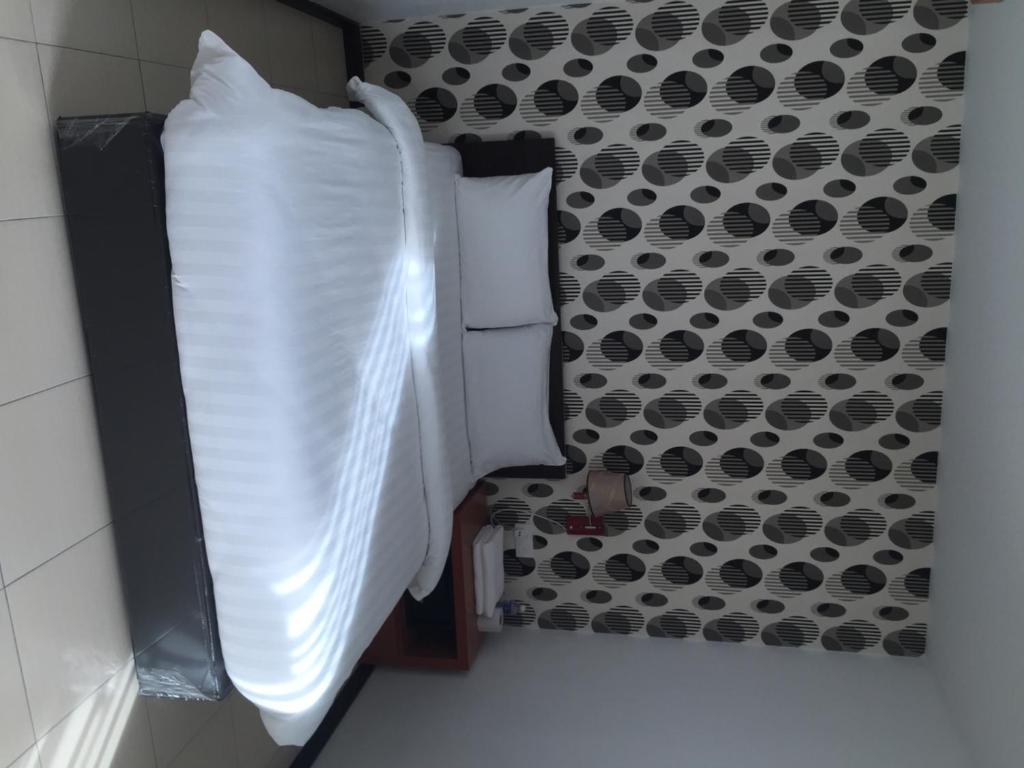 Postel nebo postele na pokoji v ubytování Permai Hotel