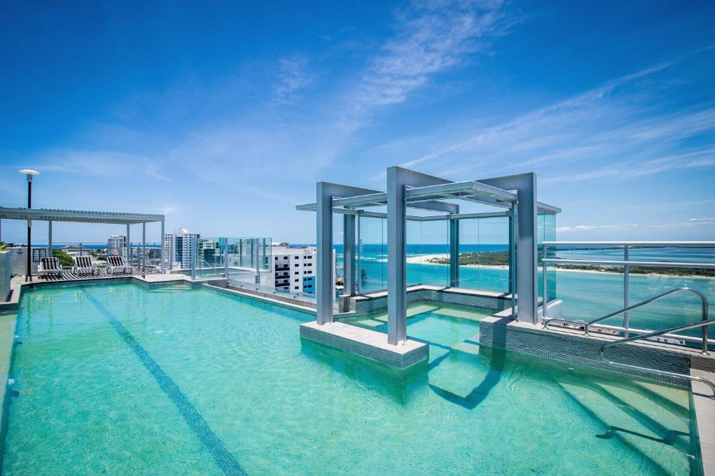 a swimming pool on the top of a building at Pumicestone Blue in Caloundra