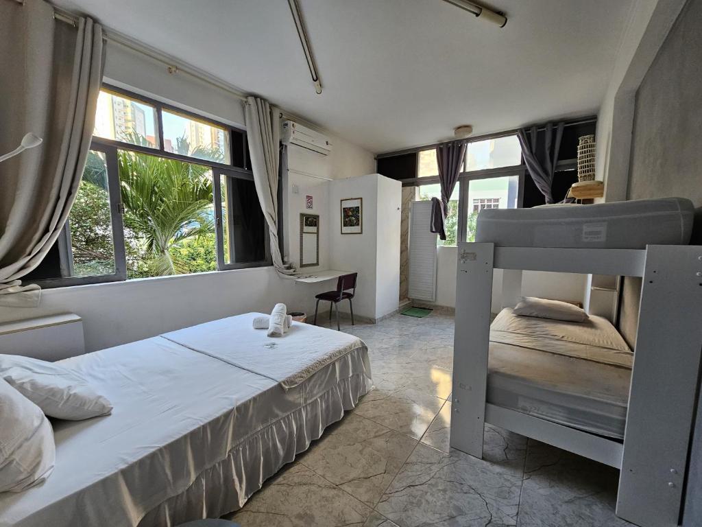 a bedroom with a bunk bed and a desk at Nomads Hostel Multicultural & Coworking in Salvador