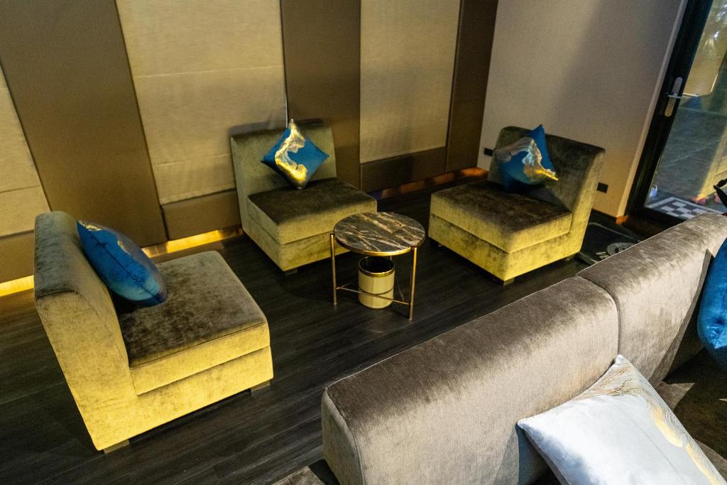 An elevated view of a compact lounge with sofas, armchairs and a central table.