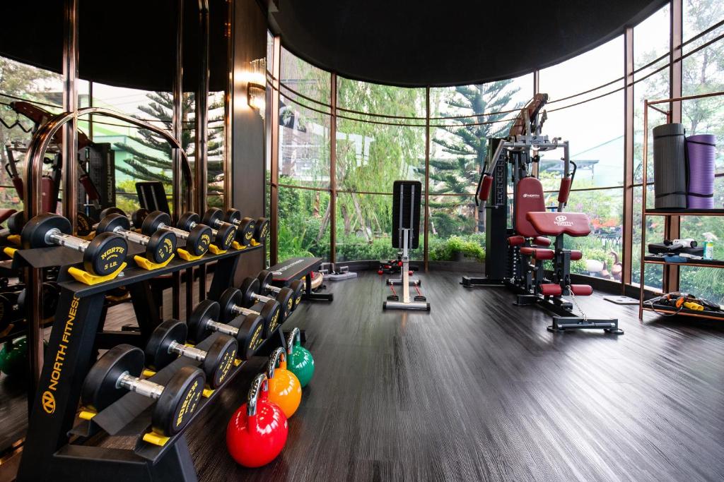 A well-equipped gym overlooking landscaped greenery.