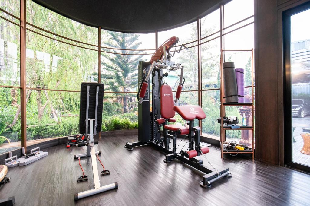 A bright, window-lined gym with a multi-station weight machine.