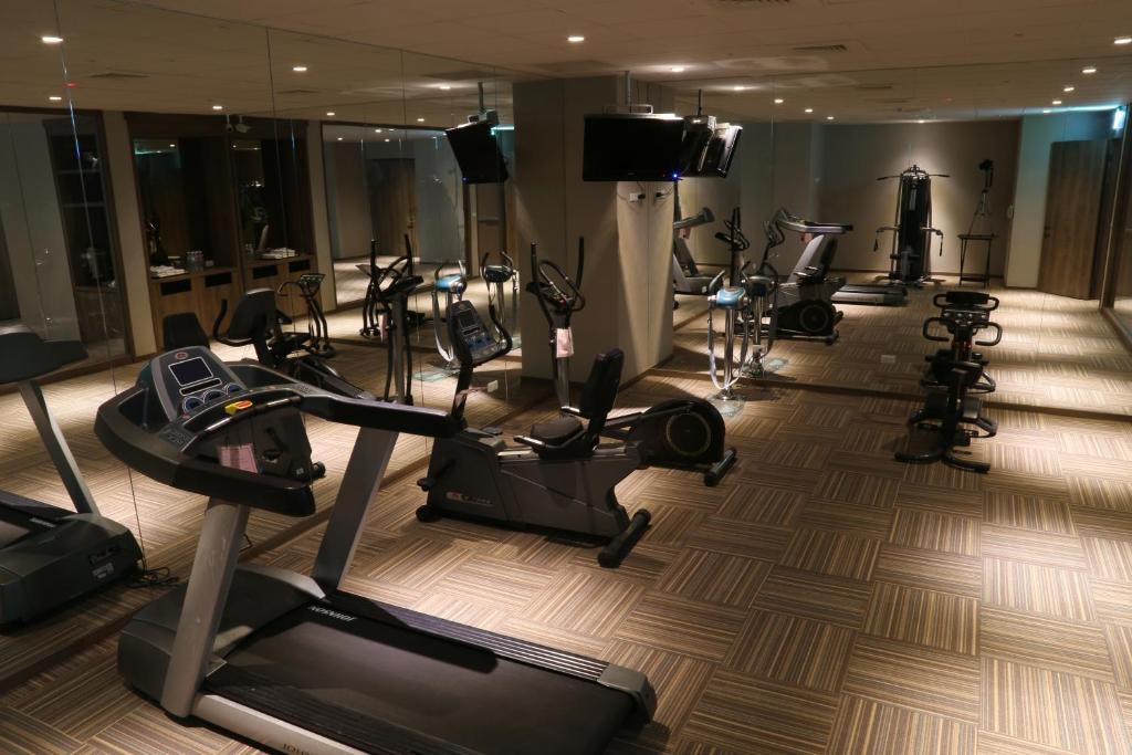 a gym with a bunch of exercise bikes and treadmills at Chiayi Maison de Chine Hotel in Chiayi City