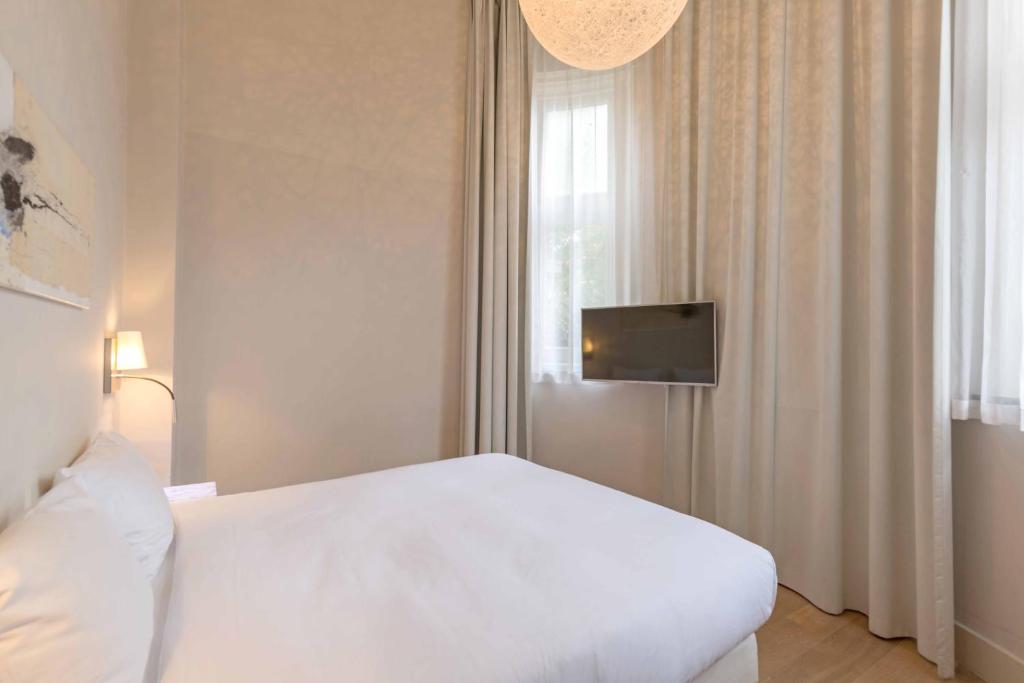 Un ou plusieurs lits dans un hébergement de l'établissement Hotel Arena