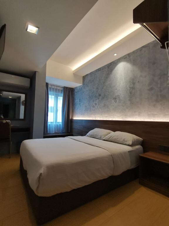Katil atau katil-katil dalam bilik di Lumut Hotel
