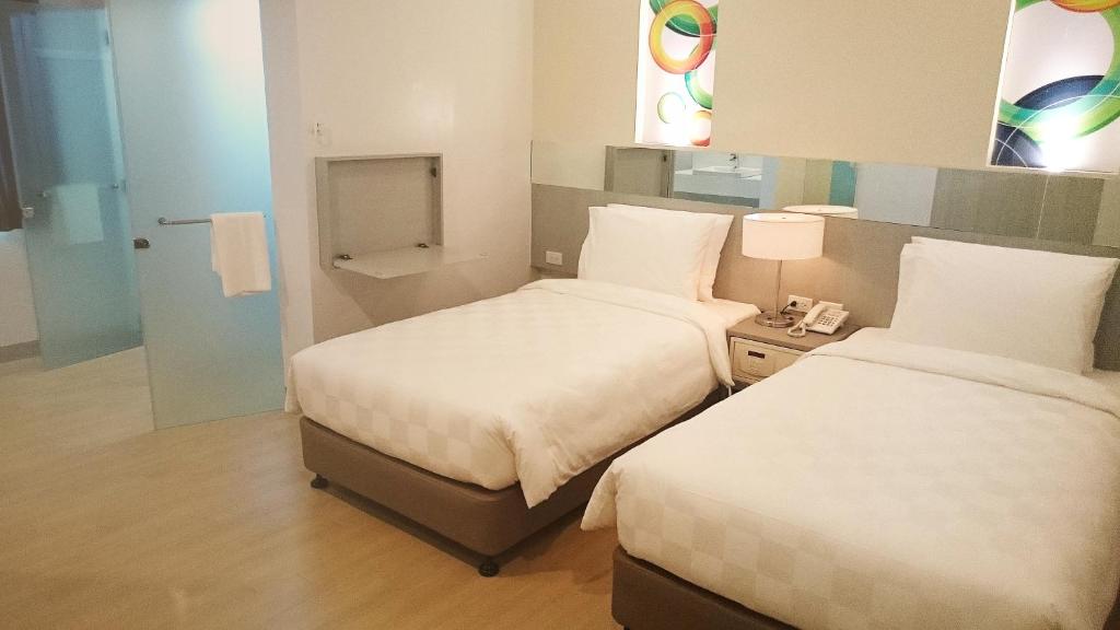 Postel nebo postele na pokoji v ubytování Go Hotels Butuan