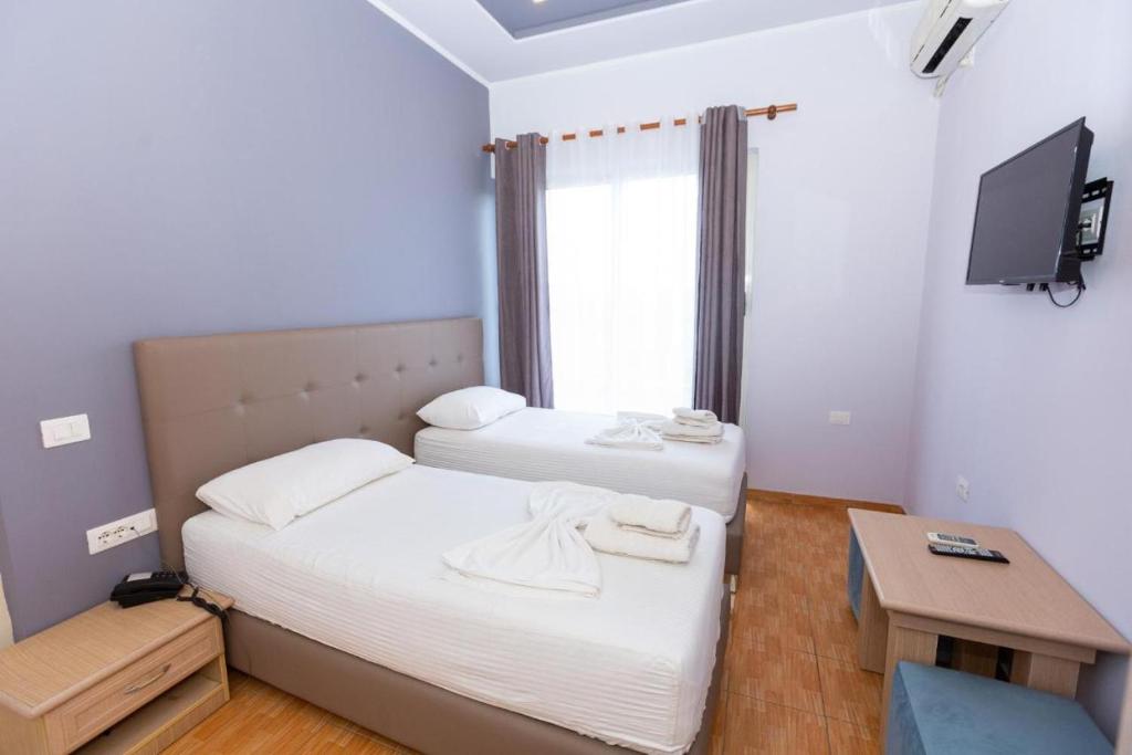 Postel nebo postele na pokoji v ubytování Hotel Triada