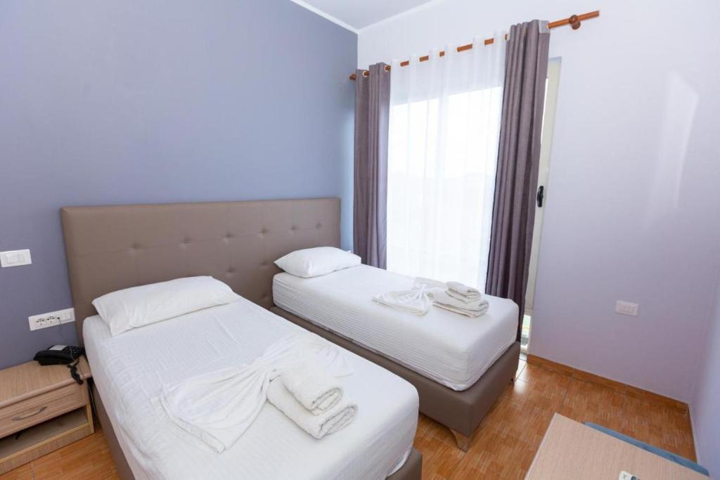 Postel nebo postele na pokoji v ubytování Hotel Triada