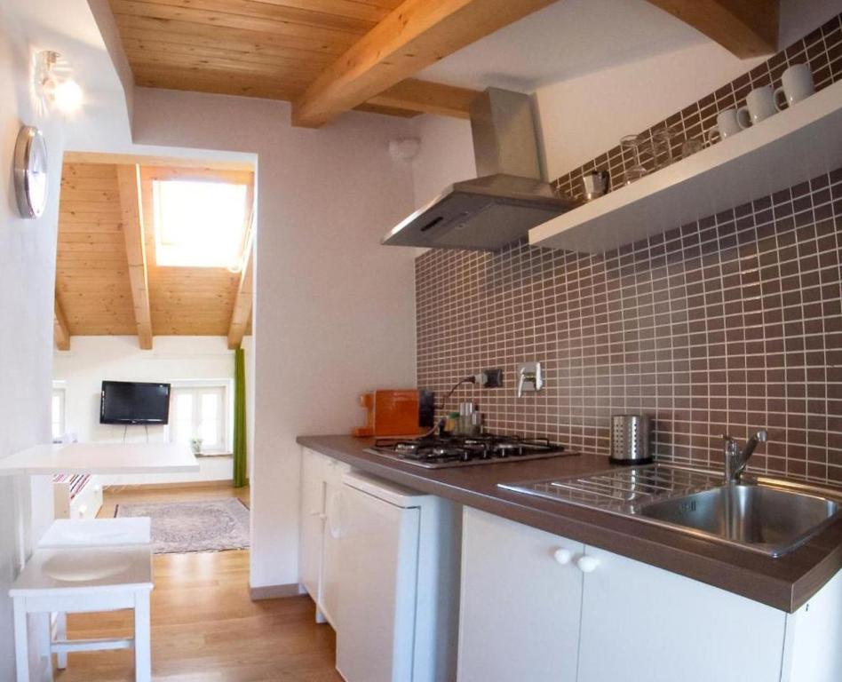 a kitchen with a sink and a counter top at Piazza Grande City Residence in Trieste