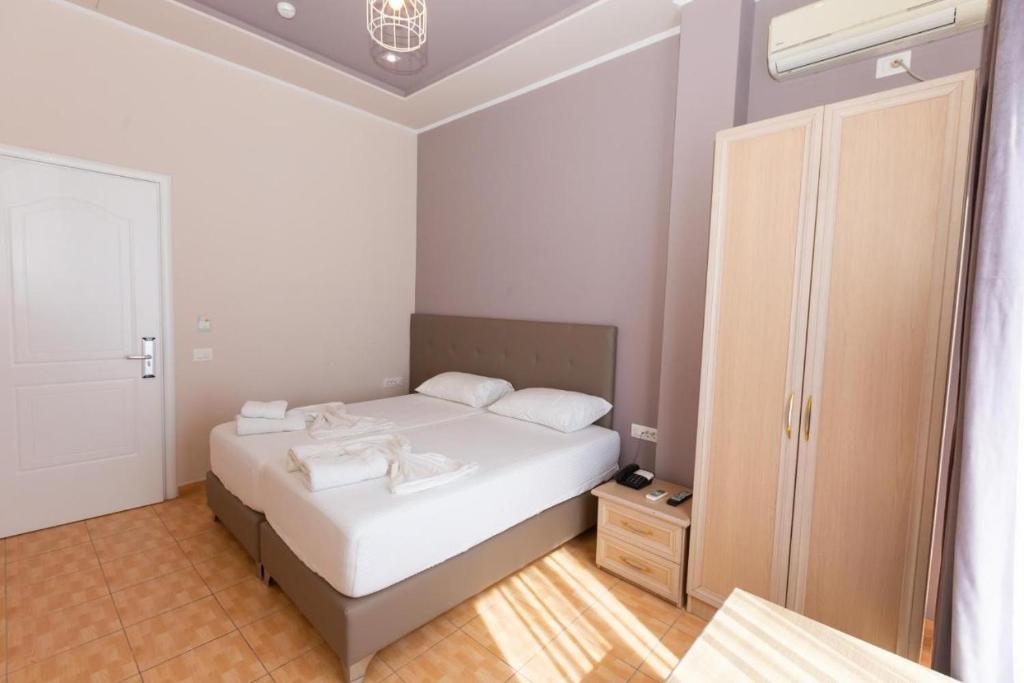 Postel nebo postele na pokoji v ubytování Hotel Triada