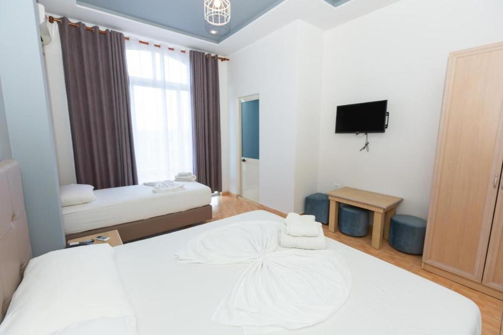 Postel nebo postele na pokoji v ubytování Hotel Triada