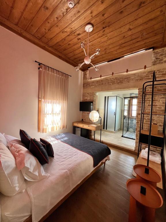 a bedroom with a large bed and a wooden ceiling at Oldies Hotel in Antalya