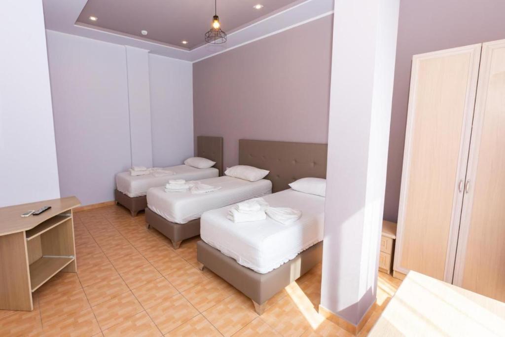 Postel nebo postele na pokoji v ubytování Hotel Triada