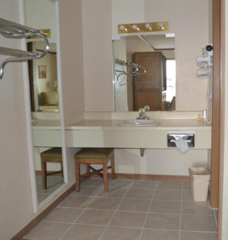a bathroom with a sink and a mirror at Night Inn in Sweet Springs
