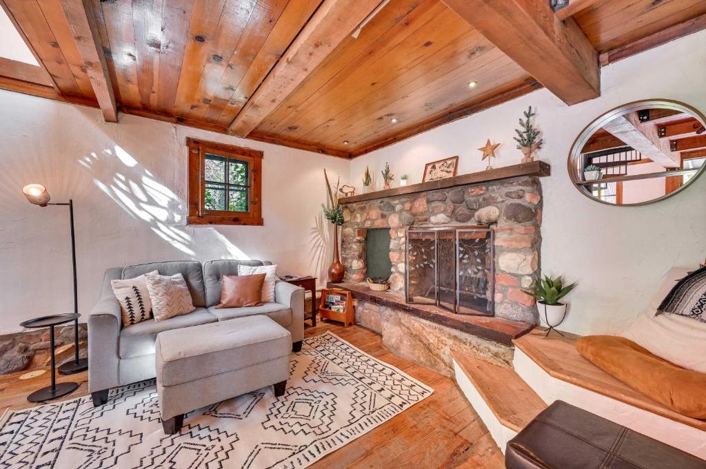 a living room with a stone fireplace at Patio and Mtn Views Peaceful Sedona Retreat in Sedona