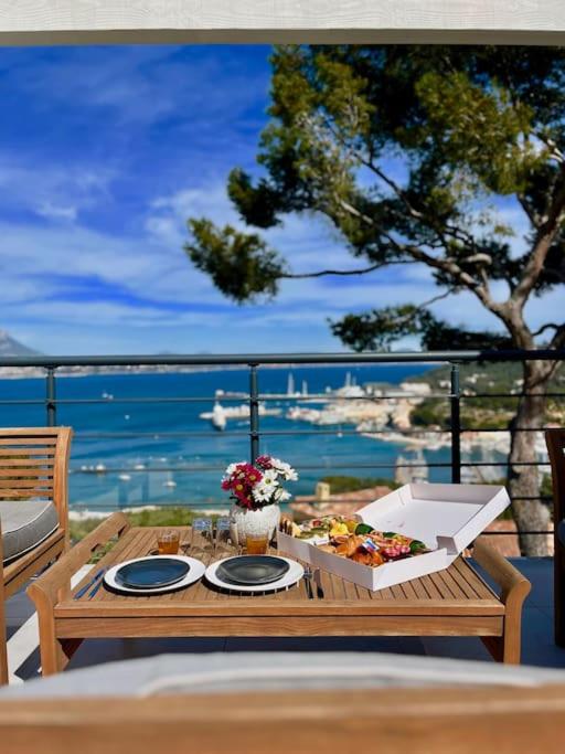 - une table avec une boîte de nourriture sur un balcon dans l'établissement Le Cap Marlou, vue mer exceptionnelle, à Saint-Mandrier-sur-Mer