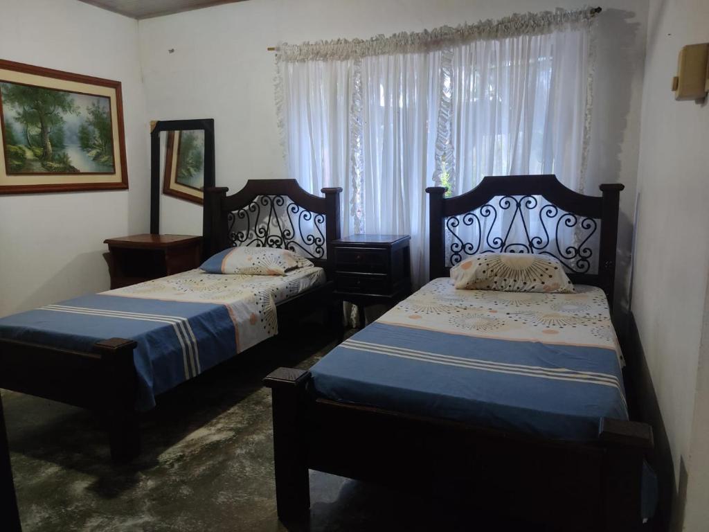 Postel nebo postele na pokoji v ubytování Hostal VILLA JULIANA