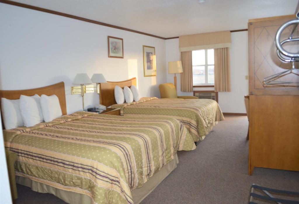 a hotel room with two beds and a window at Night Inn in Sweet Springs